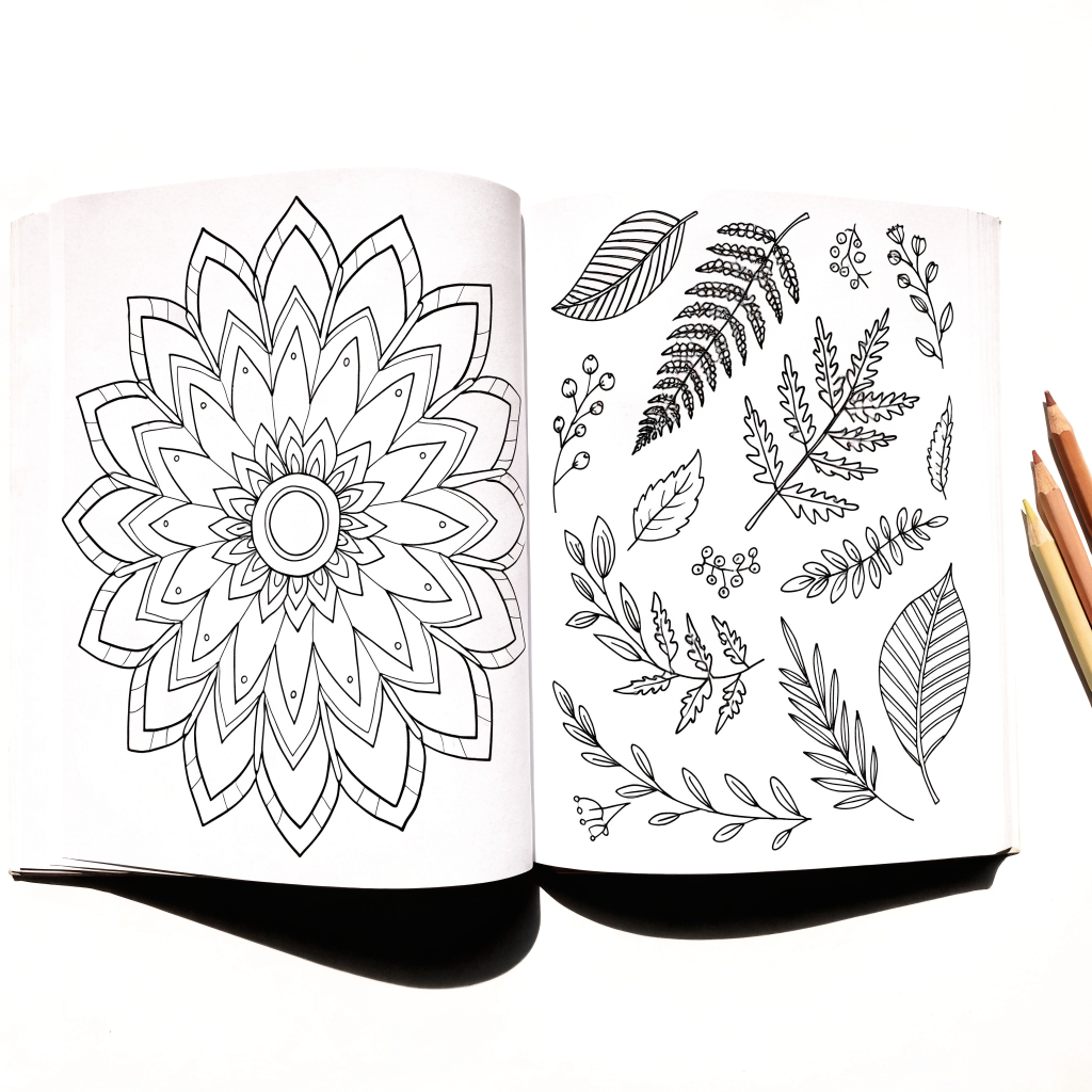 Libro para colorear abierto con mandala y hojas en línea negra